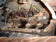 With a 15mm socket, remove the nuts at the manifold
